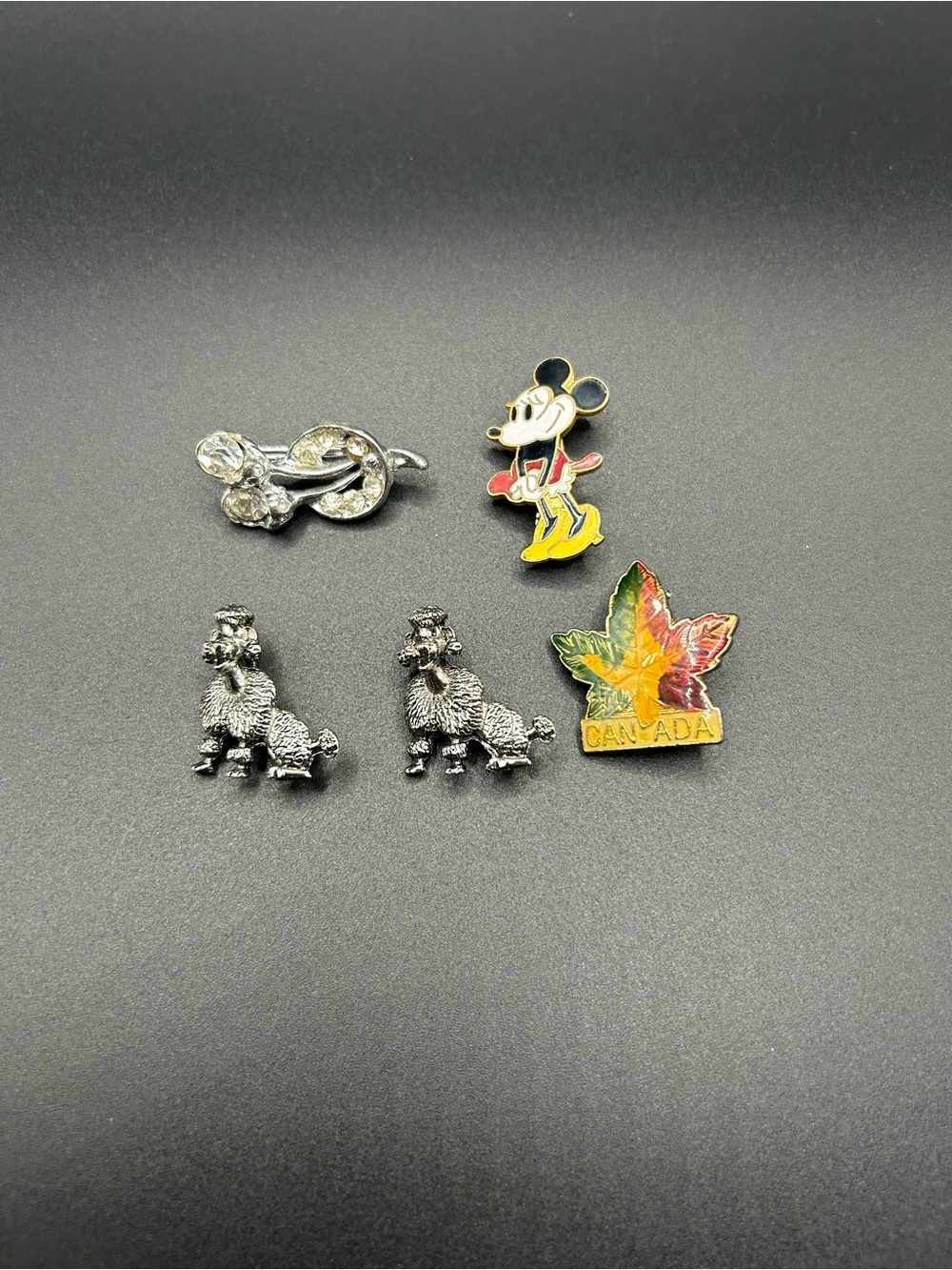 Lot of small pins and brooches , poodle , Mickey Mouse , Canadian leaf